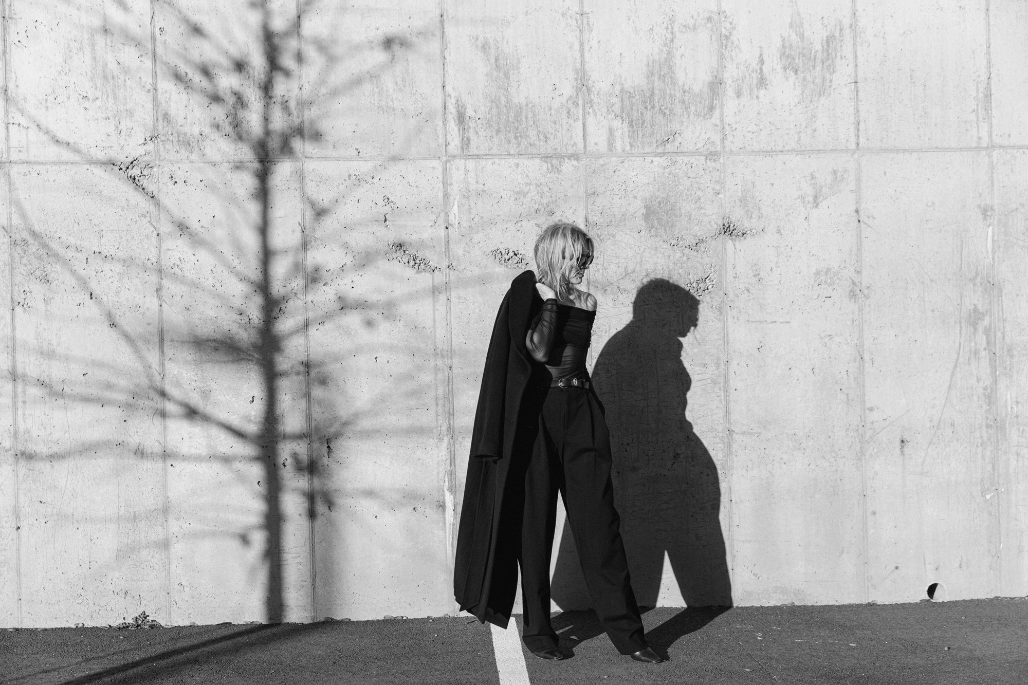 image of a woman wearing the seroya rosa top and sonya pants with the house of dagmar relaxed wool coat