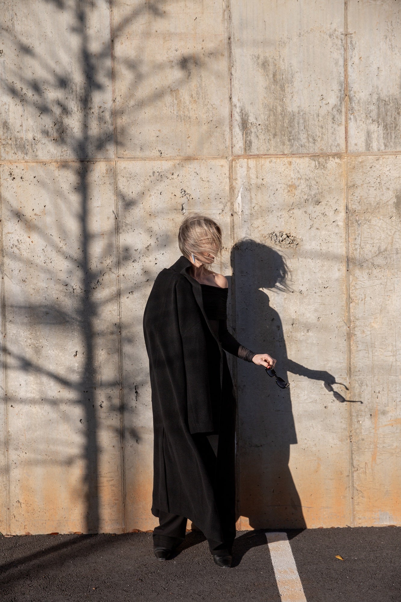 image of a woman wearing the seroya rosa top and sonya pants with the house of dagmar relaxed wool coat