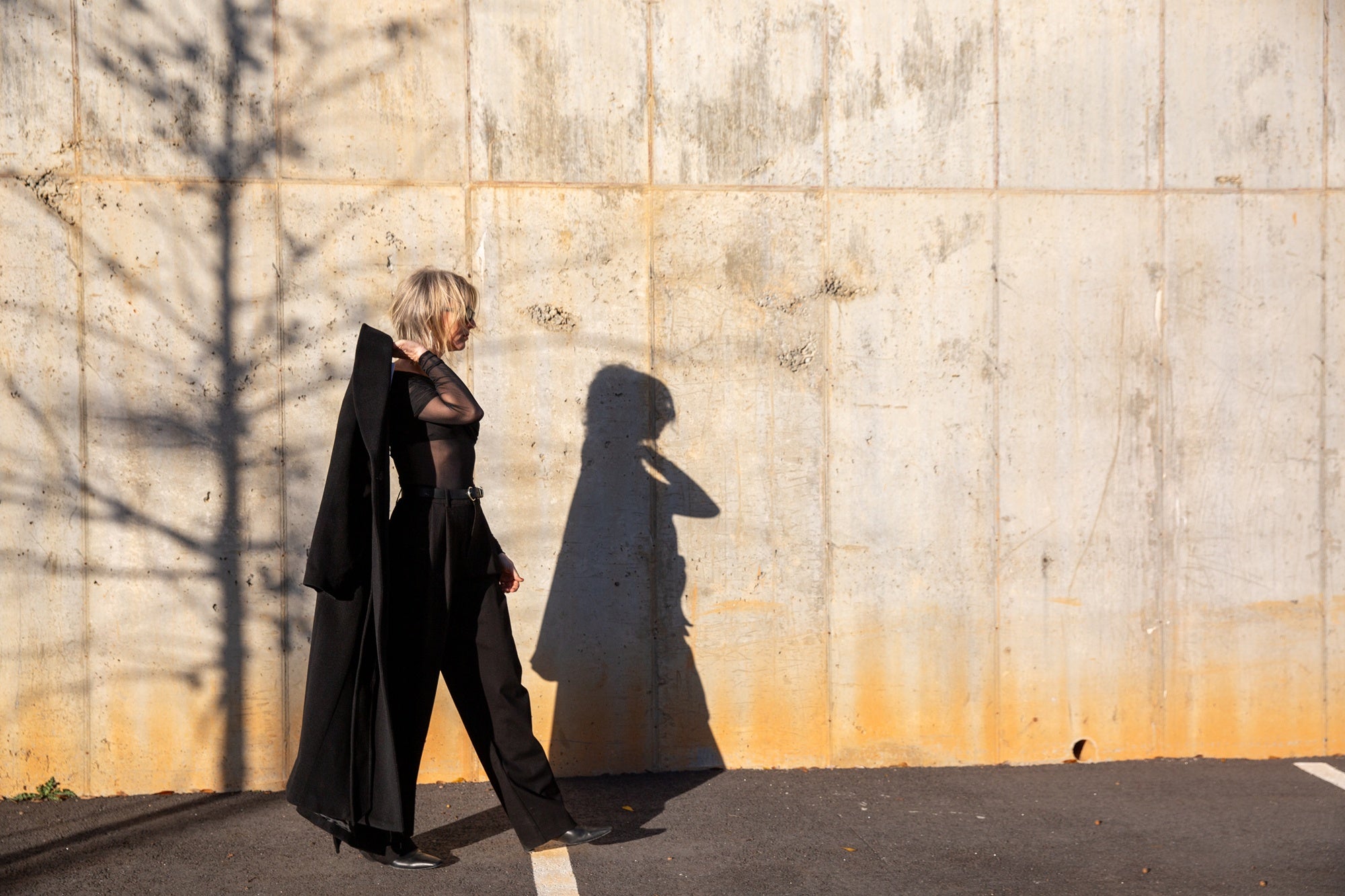 image of a woman wearing the seroya rosa top and sonya pants with the house of dagmar relaxed wool coat