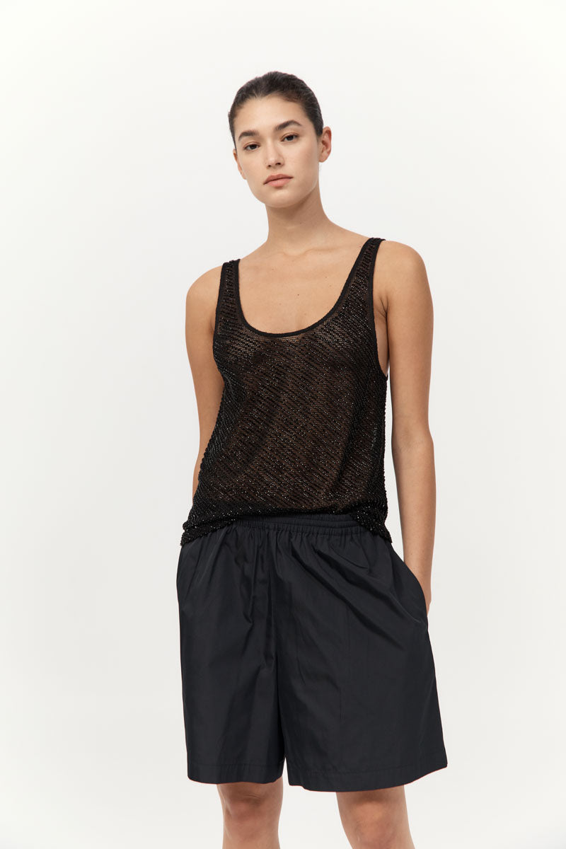 model wearing the st agni glass beaded mesh top