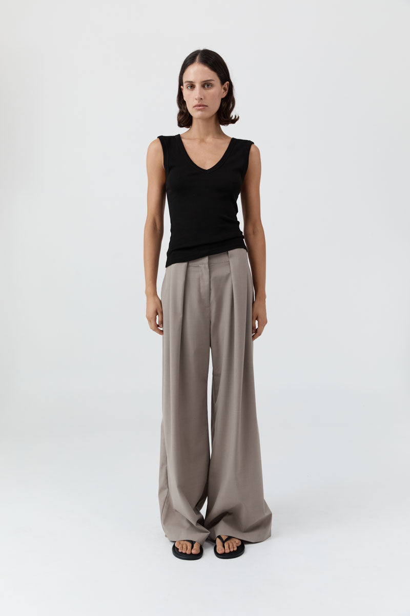 image of a woman wearing the st agni organic cotton 90's tank in black