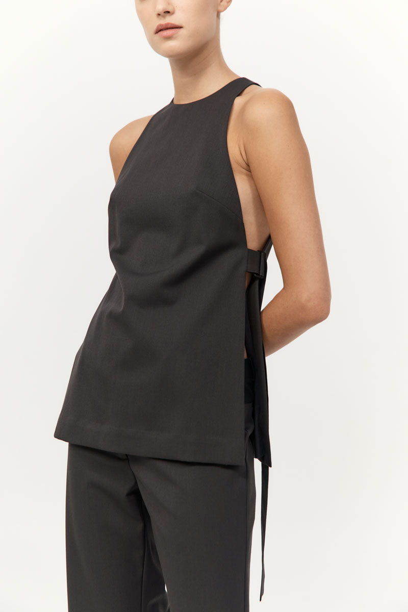 Black sleeveless top with cut-out design on a white background