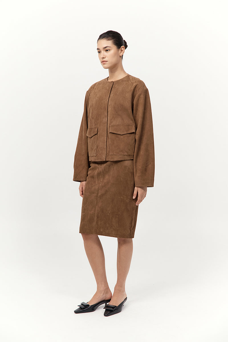 Woman wearing a brown suit on a white background