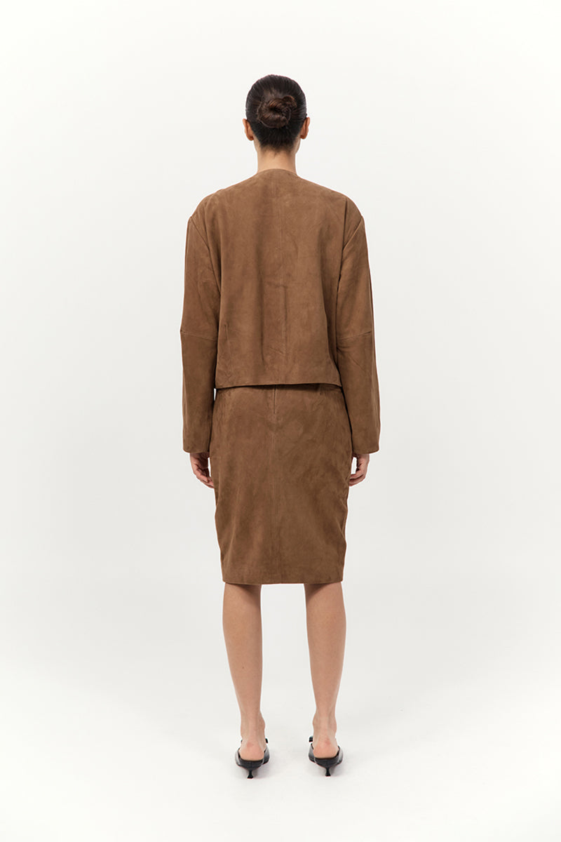 Person wearing a brown suit on a white background