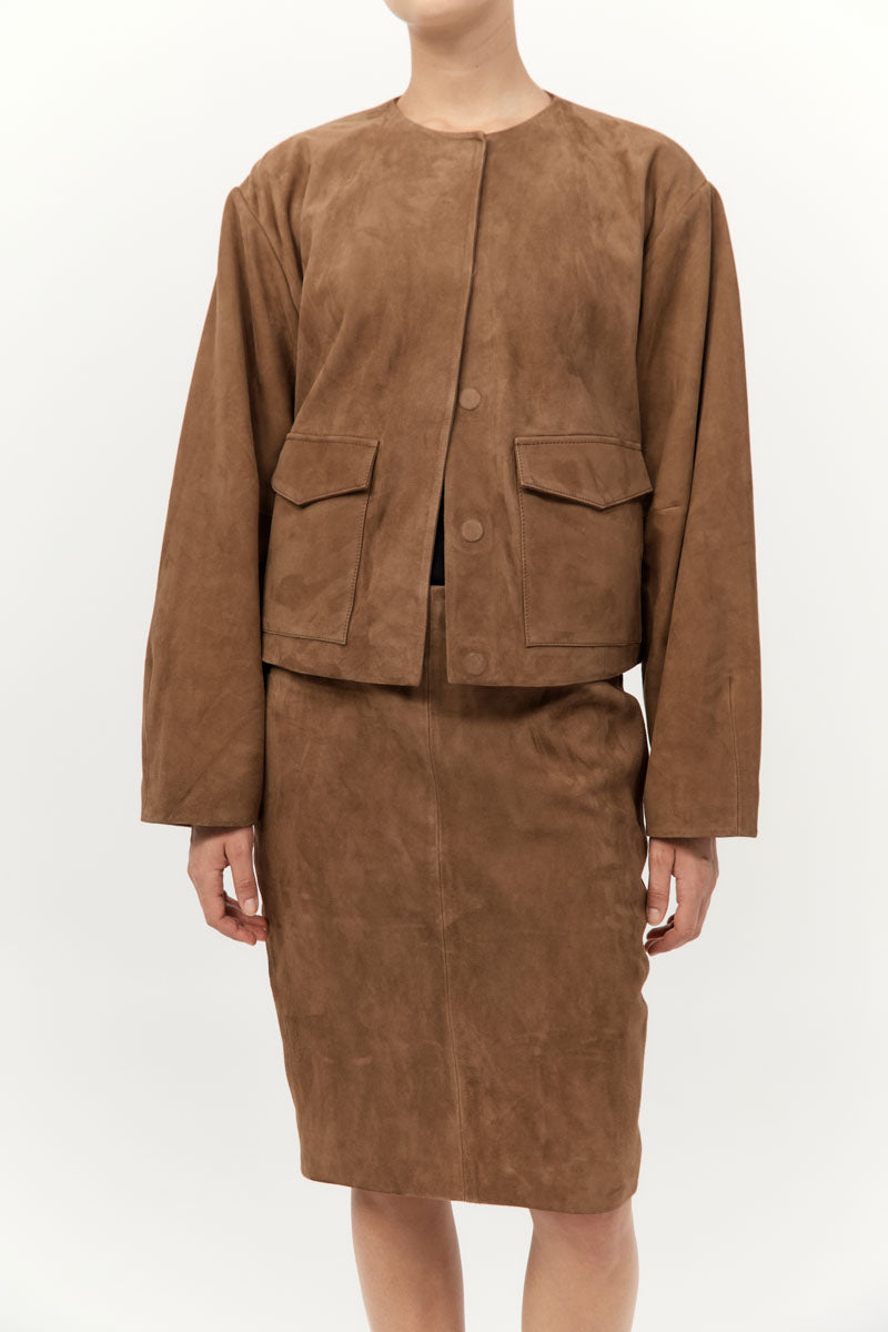 Brown suede jacket and skirt set on a white background