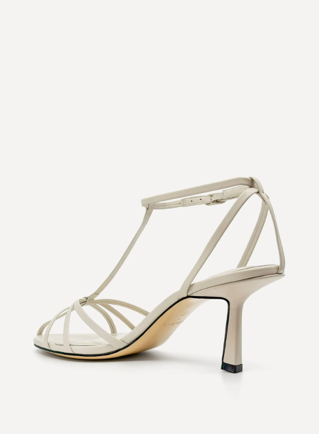 White sandal with thin straps on a white background