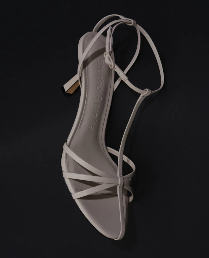 White strappy sandal on a black background