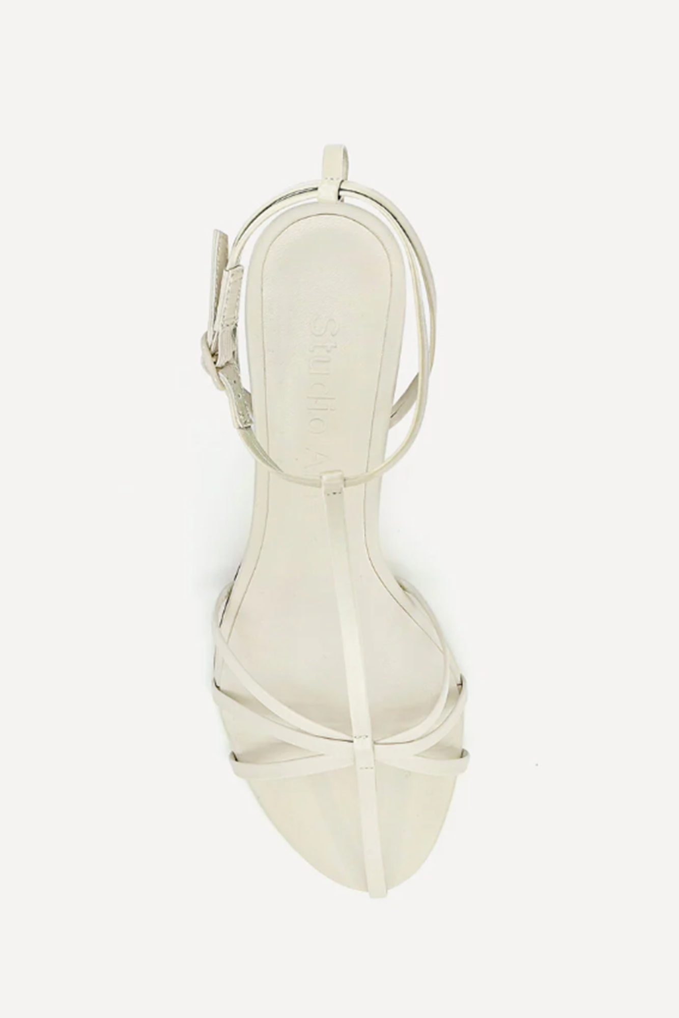 White sandal with thin straps on a white background