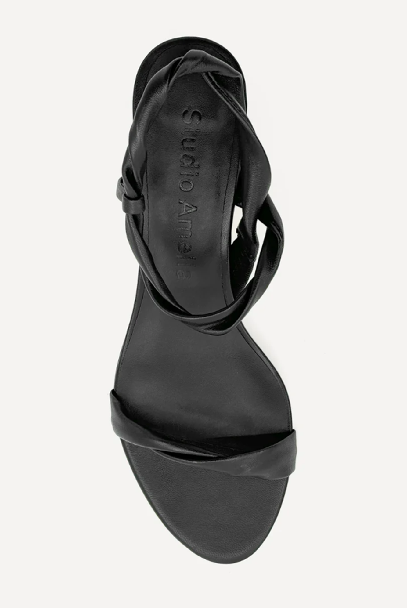 Black sandal with a strap detail on a white background