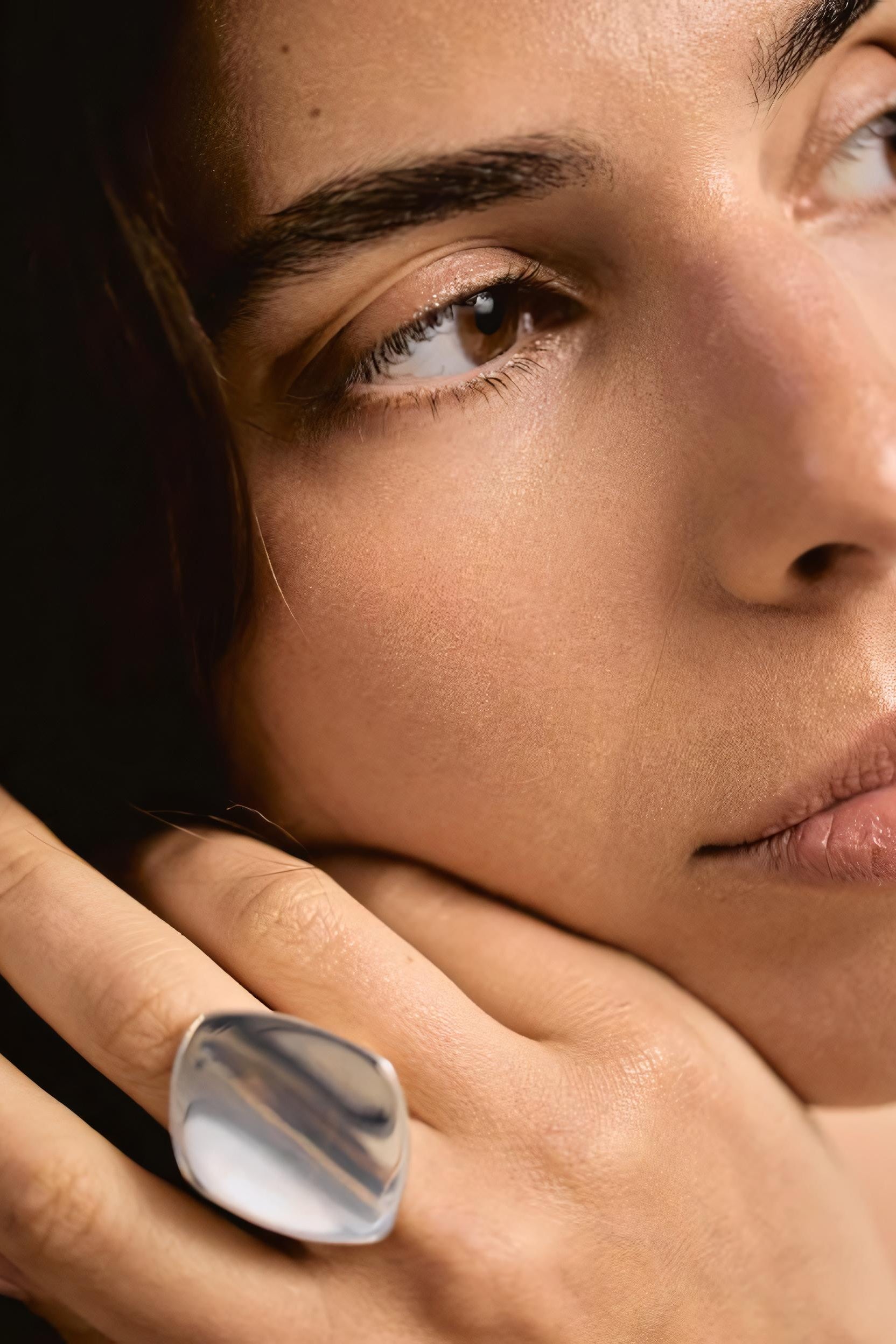 Close-up of a person wearing a silver ring on their finger.