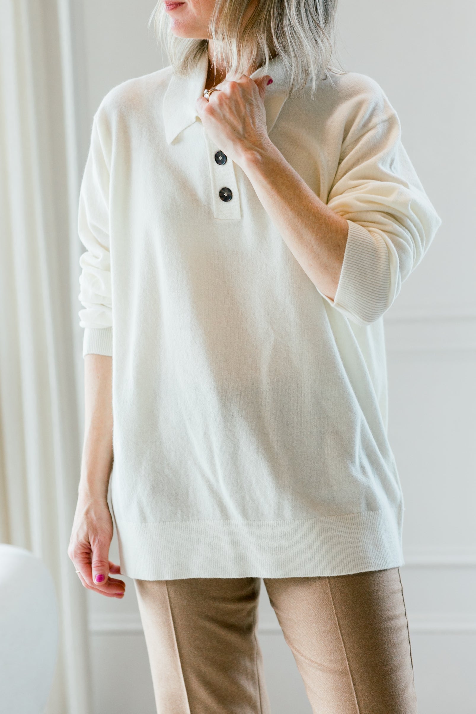 image of a woman wearing the garment como polo sweater