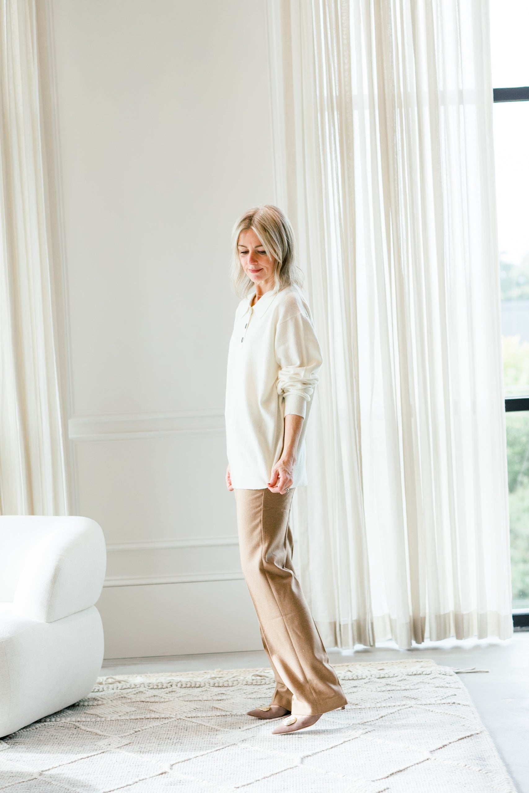 image of a woman wearing the garment como polo sweater