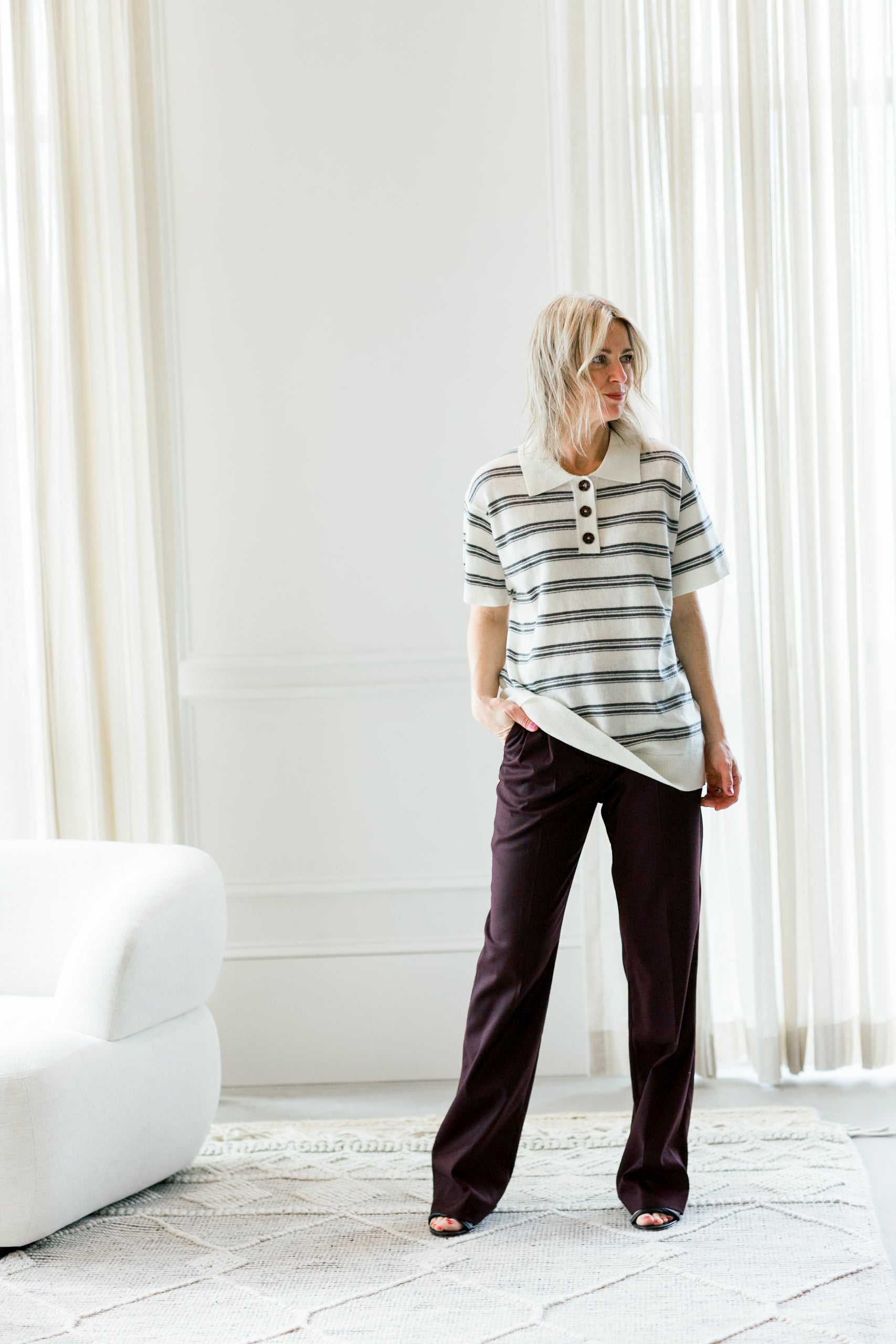image of a woman wearing the garment dad polo in ivory stripe