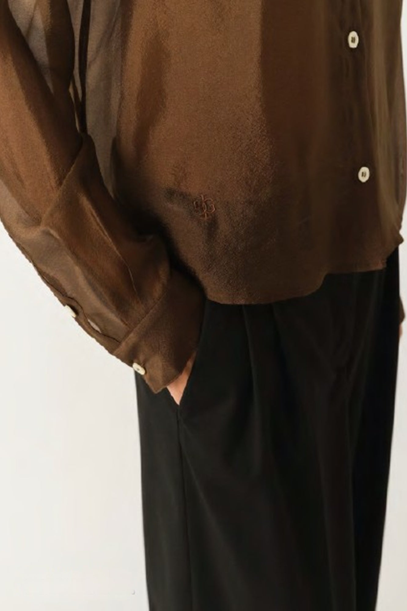 Brown shirt and black pants on a white background