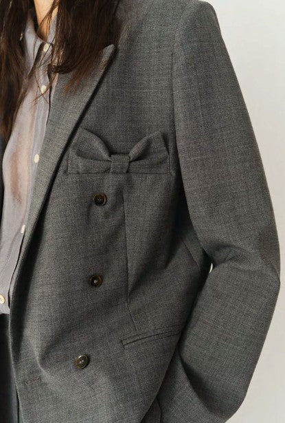 Gray blazer with buttons on a plain background