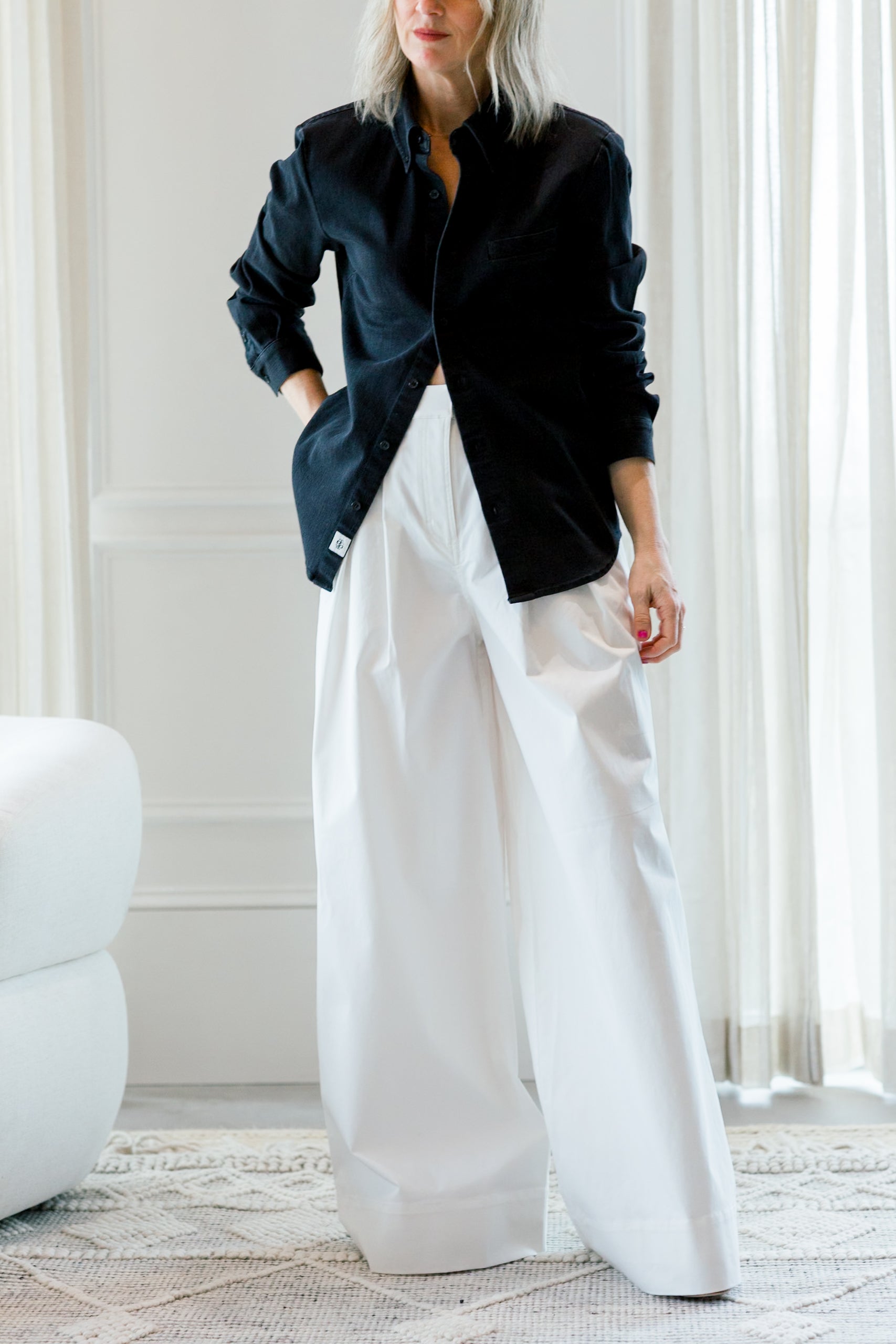 image of a woman wearing the garment merci placket shirt