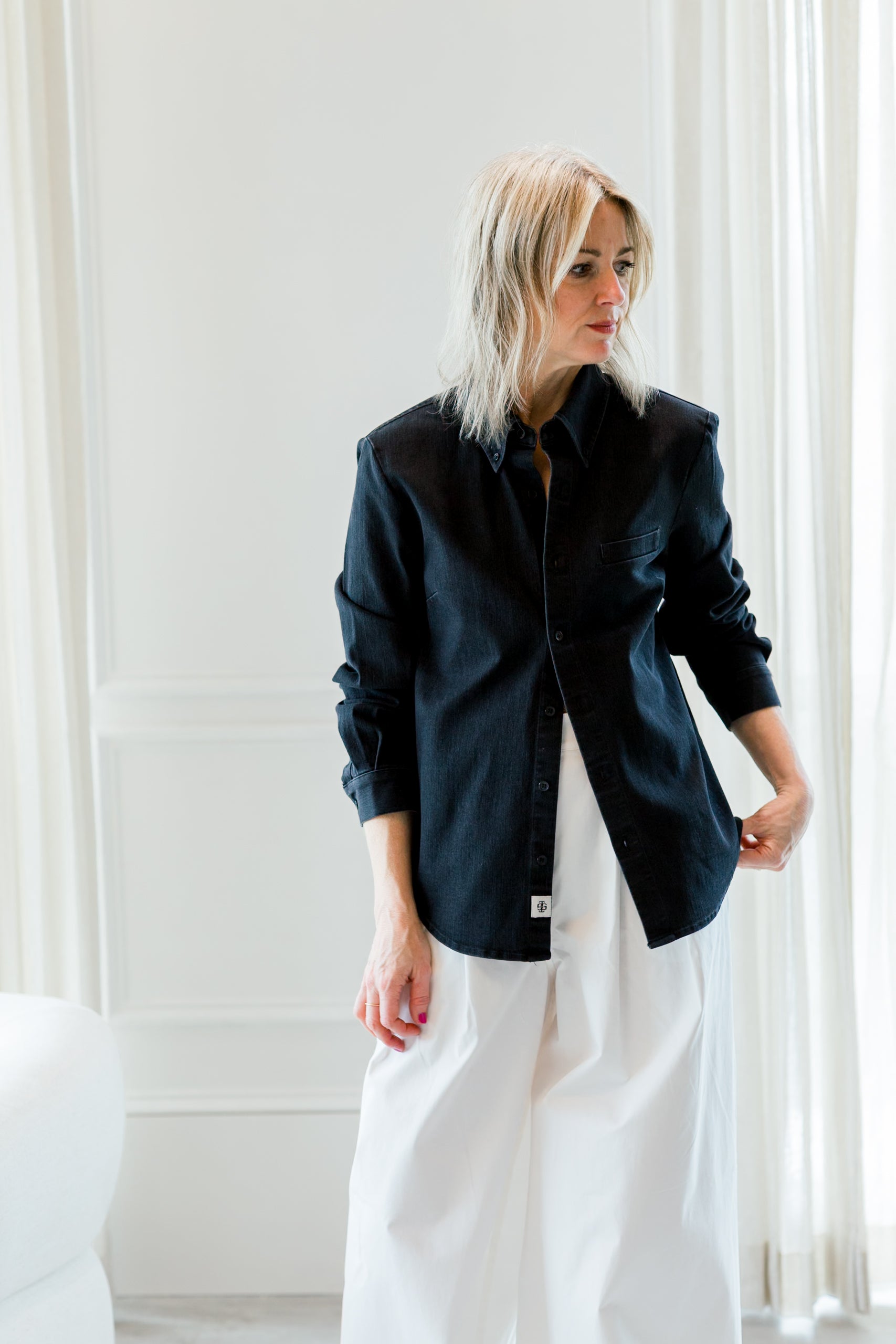 image of a woman wearing the garment merci placket shirt and avelino pants
