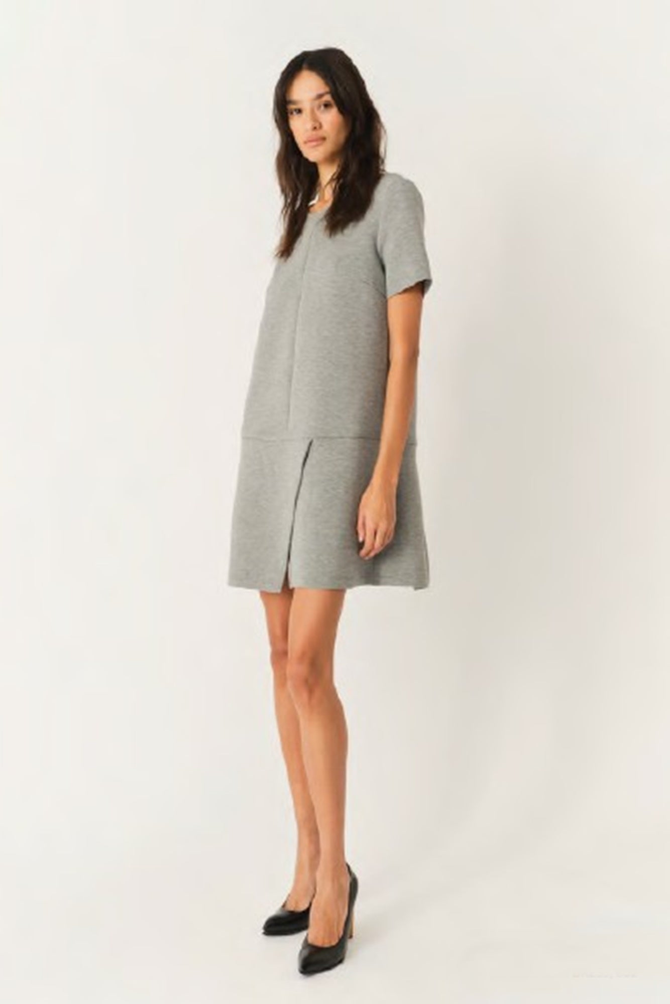 Woman wearing a gray dress on a white background
