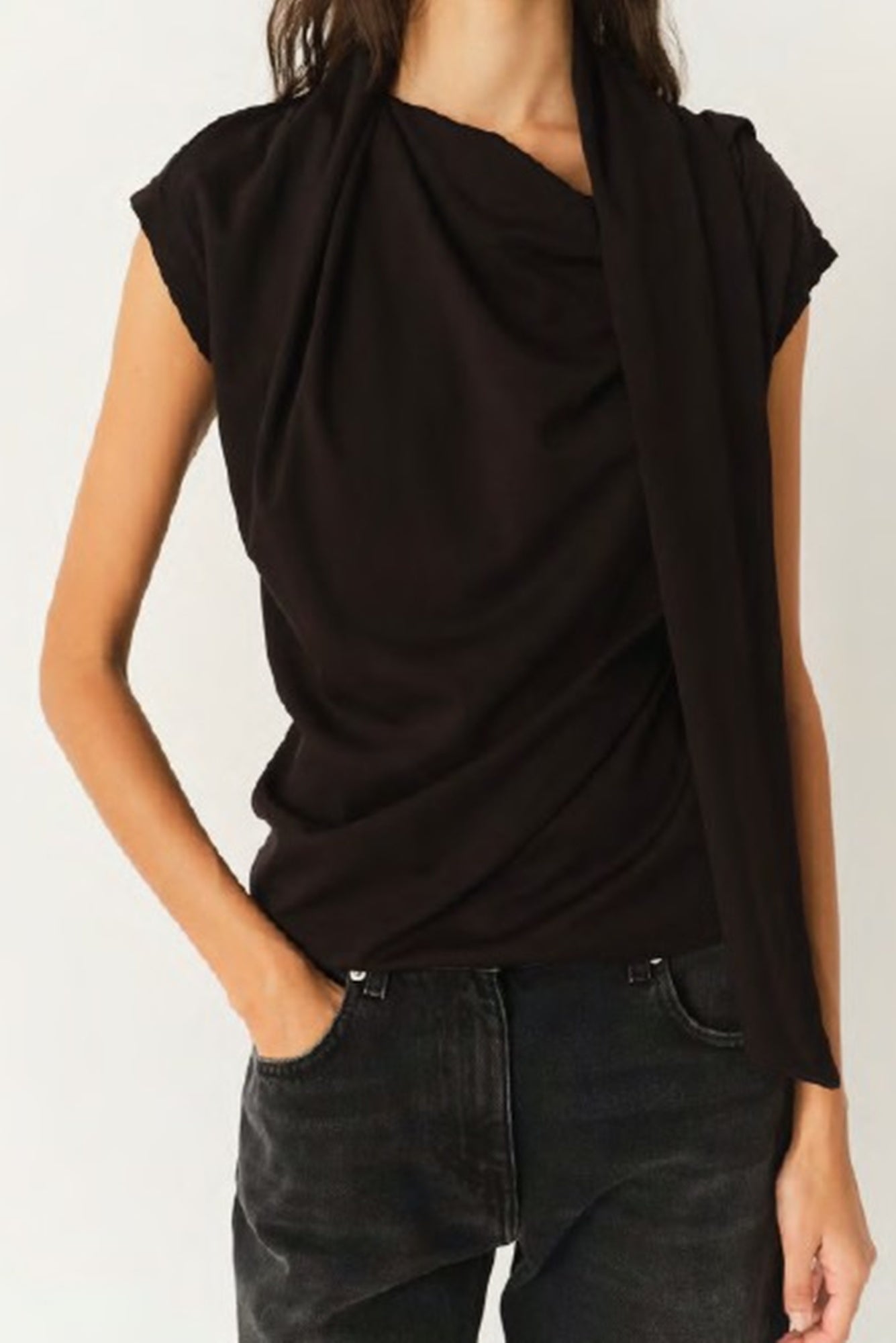 Black sleeveless top worn by a person on a white background