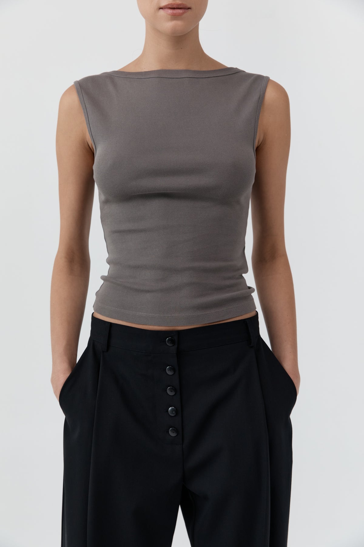 Close up of a woman wearing St Agni Organic Cotton Ballerina Top in clay standing against a white background