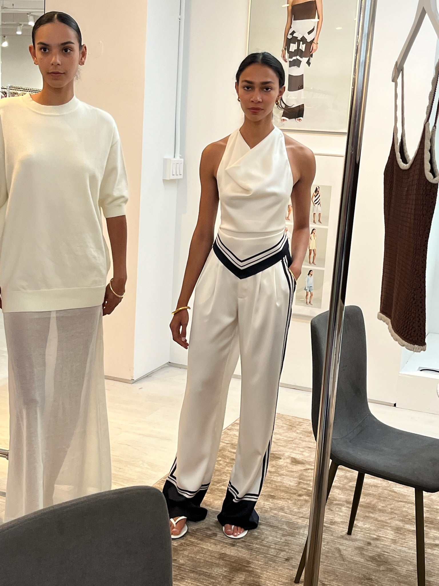 Woman wearing the seroya marlowe satin pants standing in a carpeted room with white walls