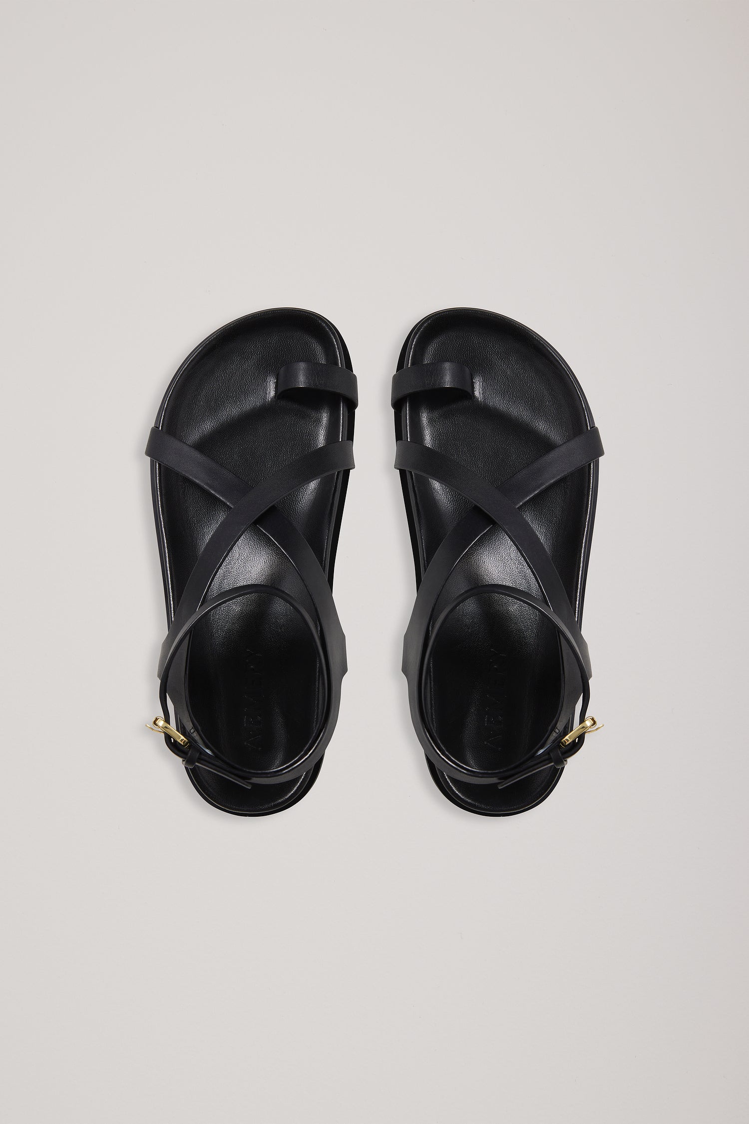 Pair of black sandals on a light gray background