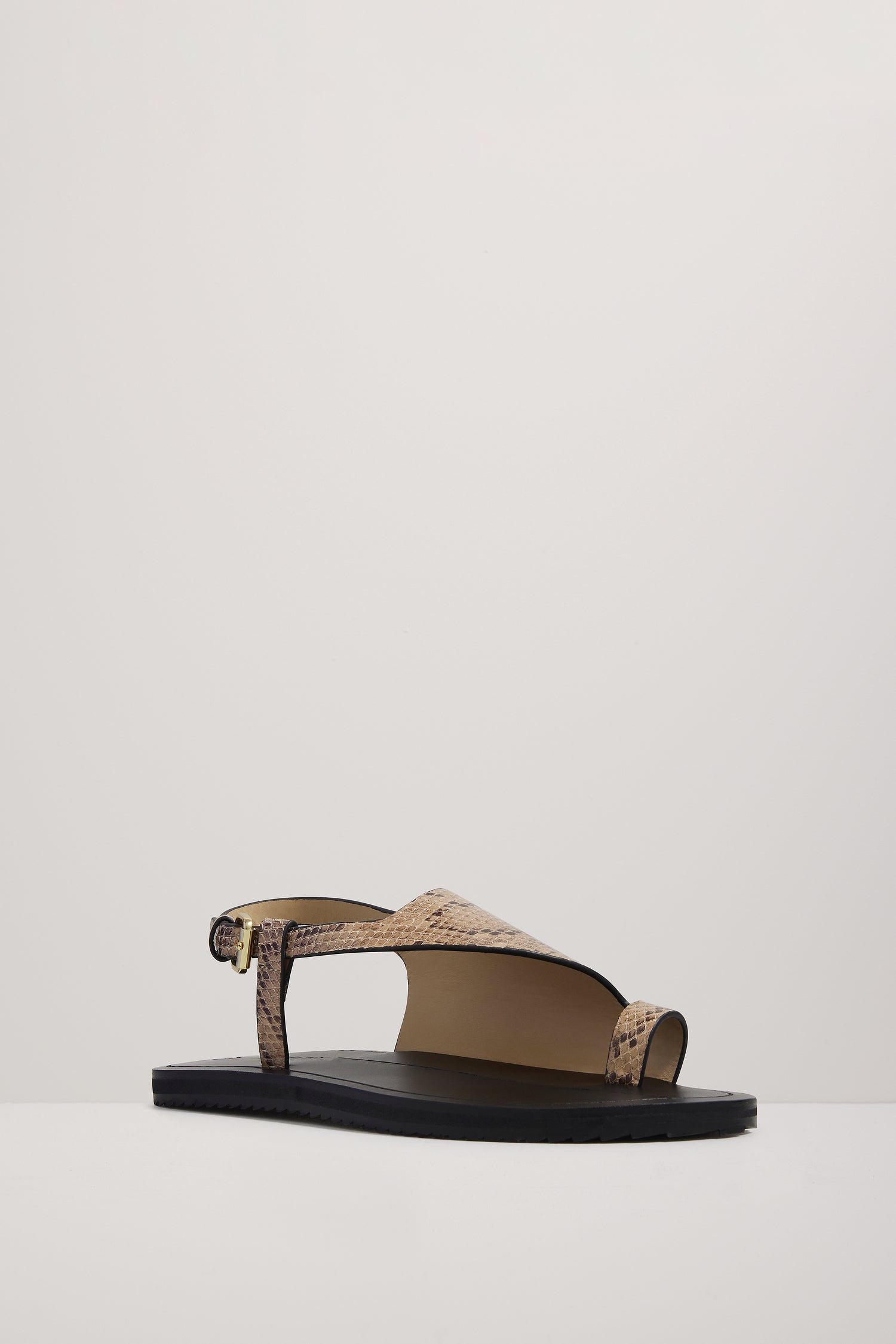 Single sandal with cork texture on a light gray background