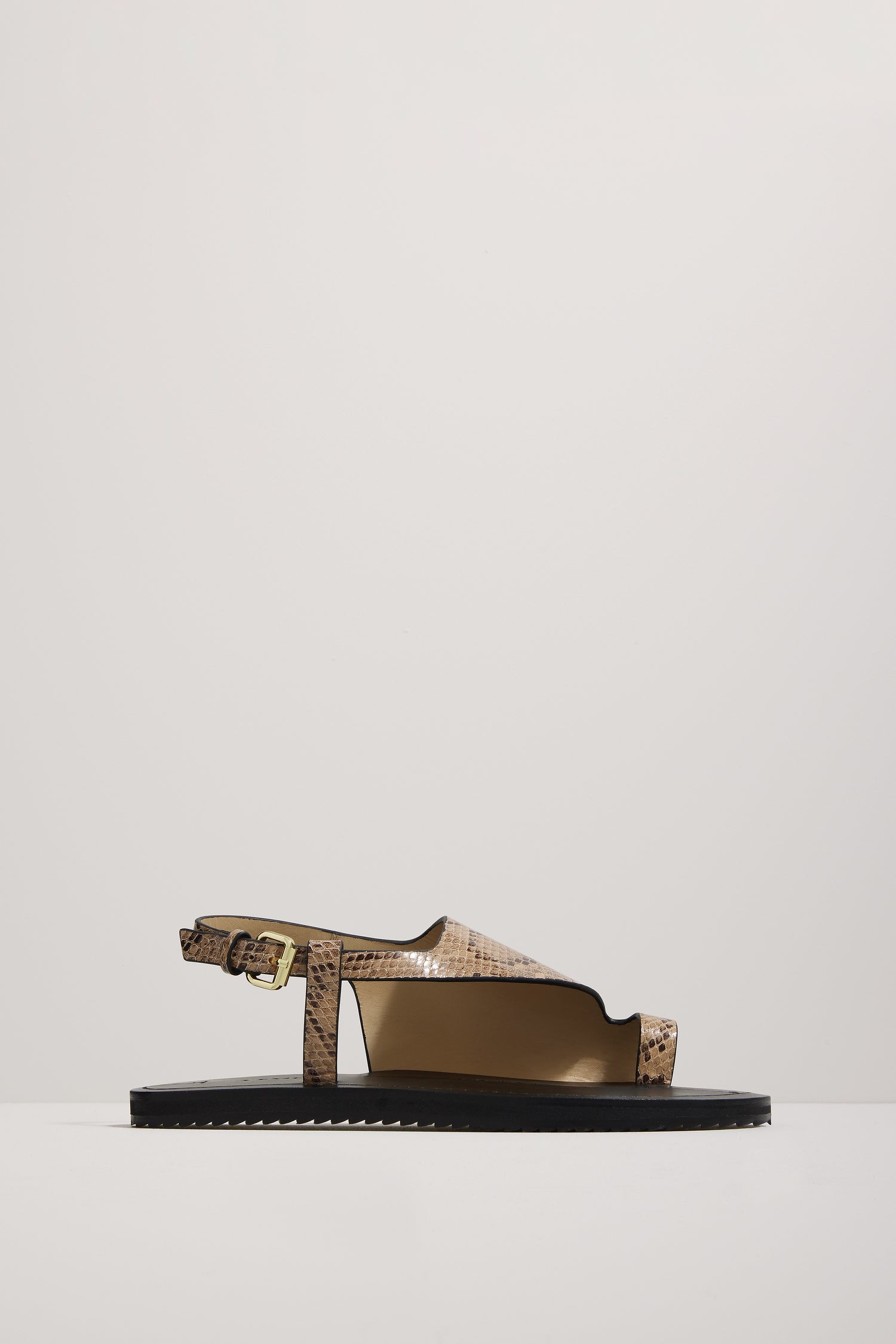 Snake print sandal on a light gray background