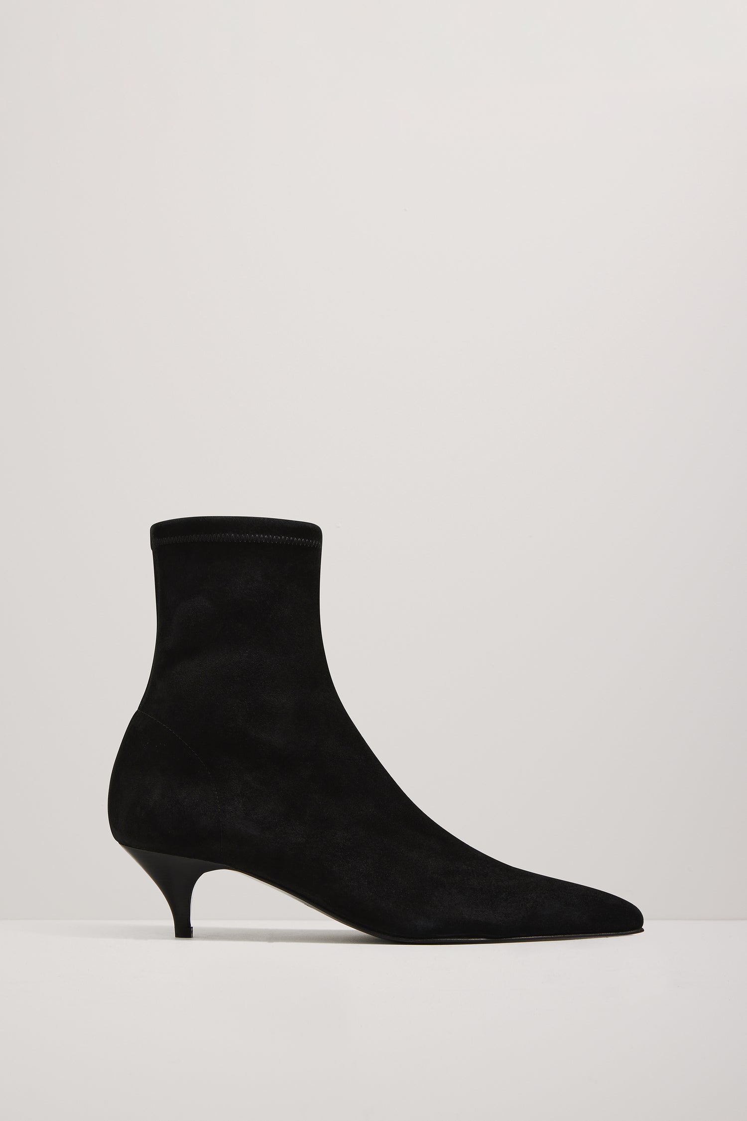 Black sock boot on a white background