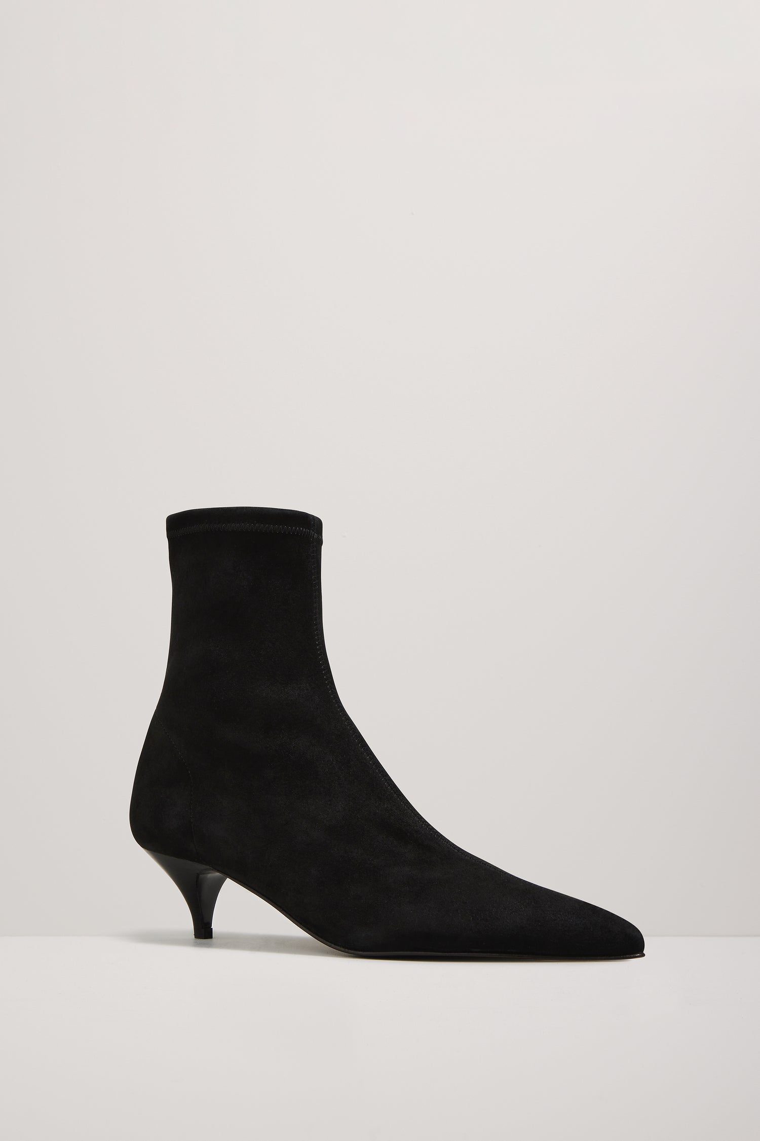Black sock boot on a light gray background