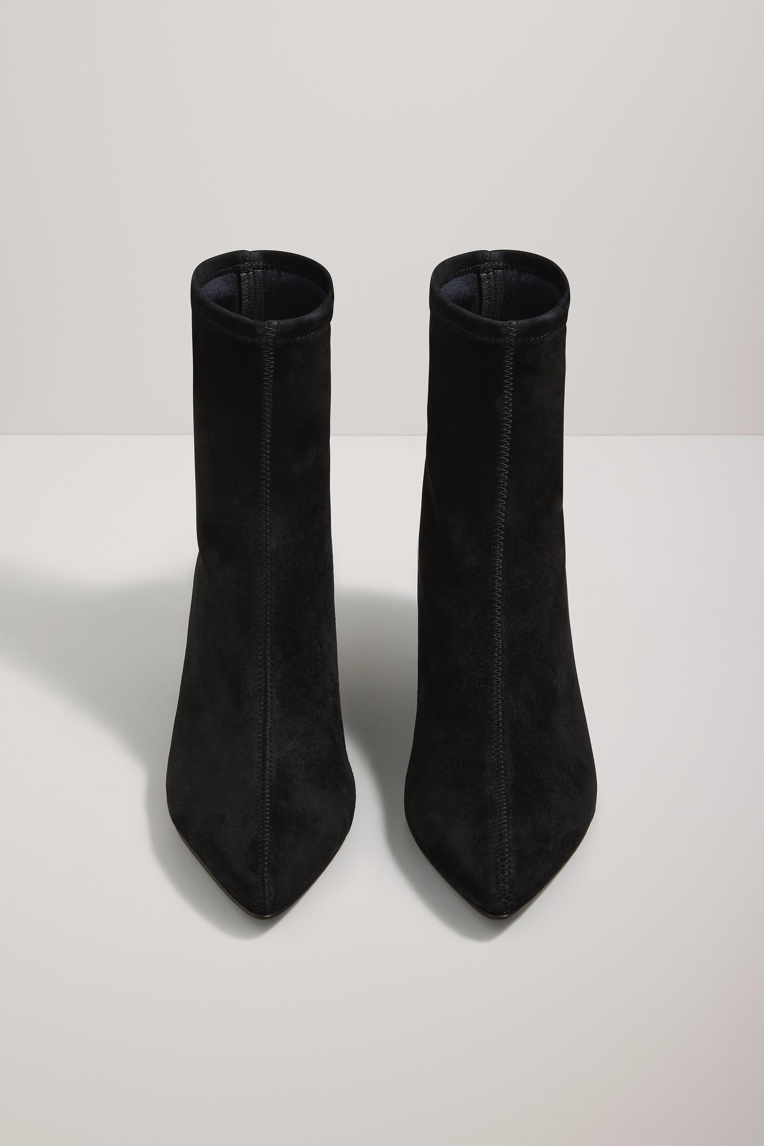 Pair of black ankle boots on a white background