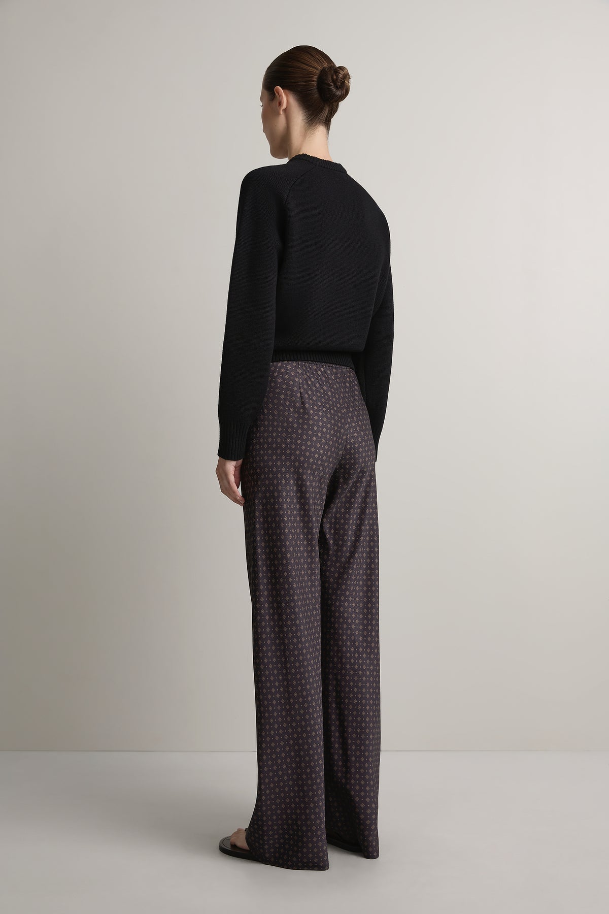Backside of Woman wearing A Emery Estee Bias Pant in Ink Foulard against a neutral background