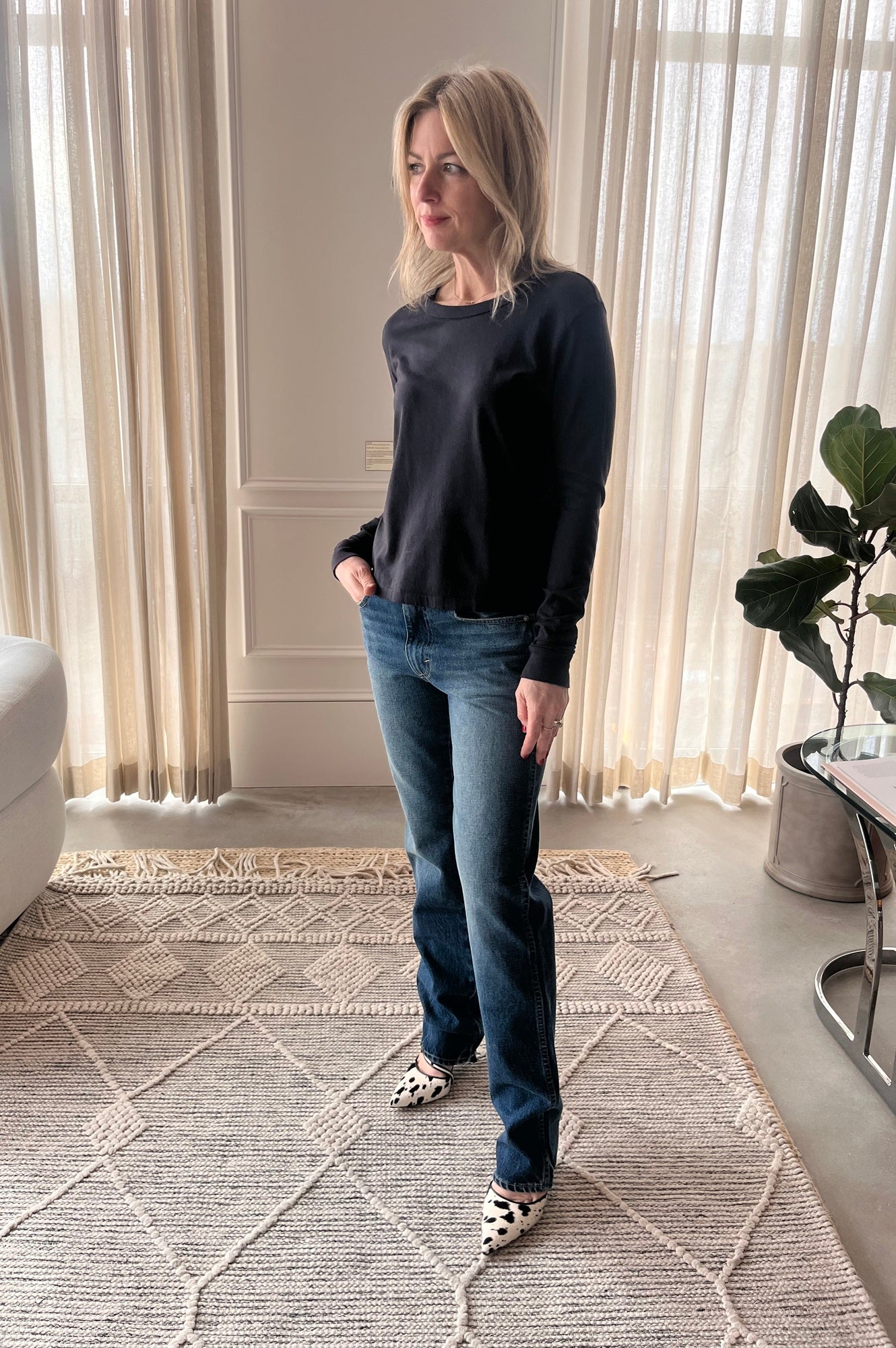 image of a woman wearing the Amo Long Sleeve Tee and Mira Jeans with the Studio Amelia Alto Cow Mules
