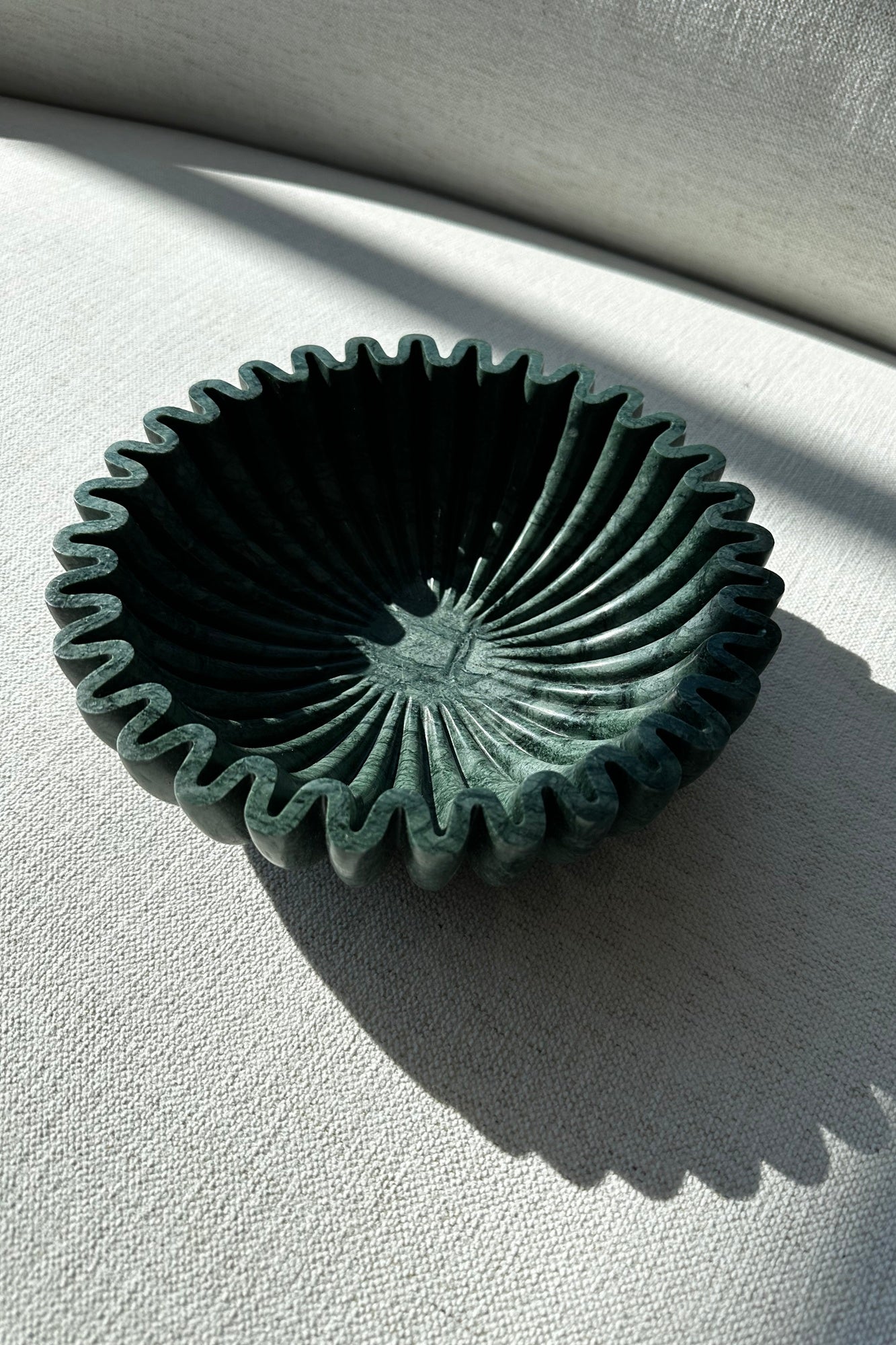 emerald stone ruffle bowl against white background 