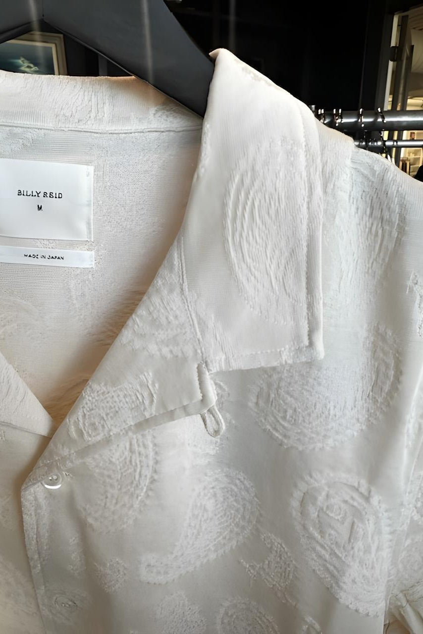 White textured fabric with a label on a blurred background