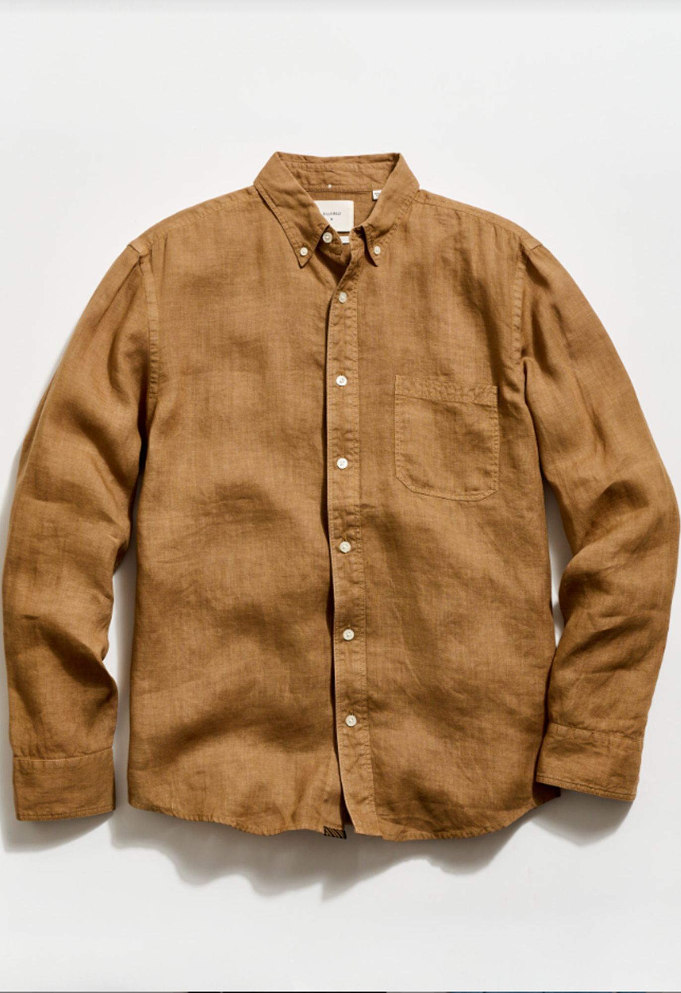 Brown button-up shirt on a white background