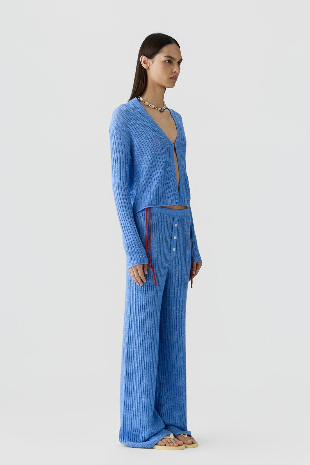 side image of a model wearing the Guest in Residence Rib Stealth Cardigan in Delft Blue