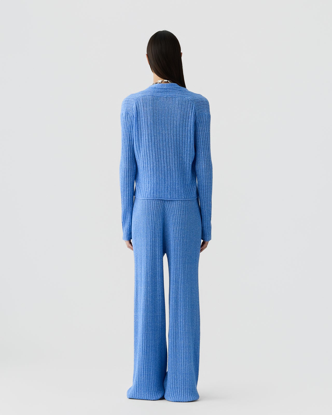 Back image of a woman wearing the Guest in Residence Rib Stealth Cardigan in Delft Blue