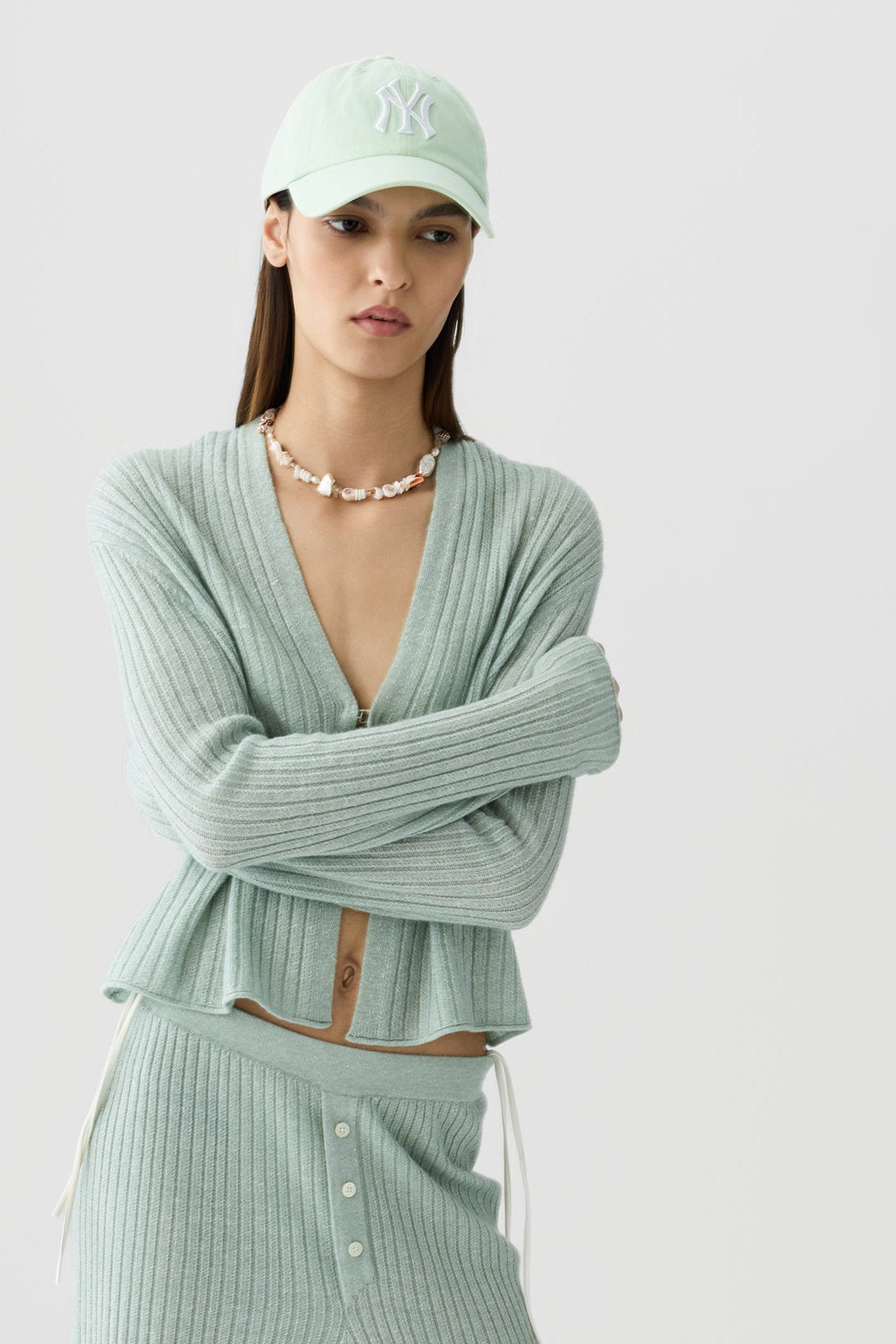 image of a model wearing the Guest in Residence Rib Stealth Cardigan in Sage Brush
