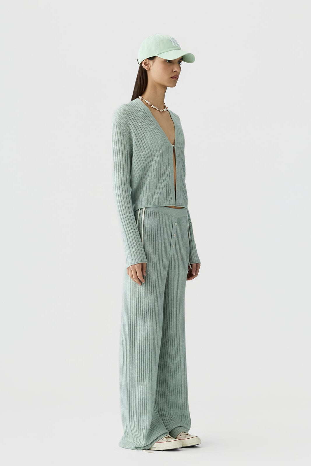 image of a model wearing the Guest in Residence Rib Stealth Cardigan in Sage Brush