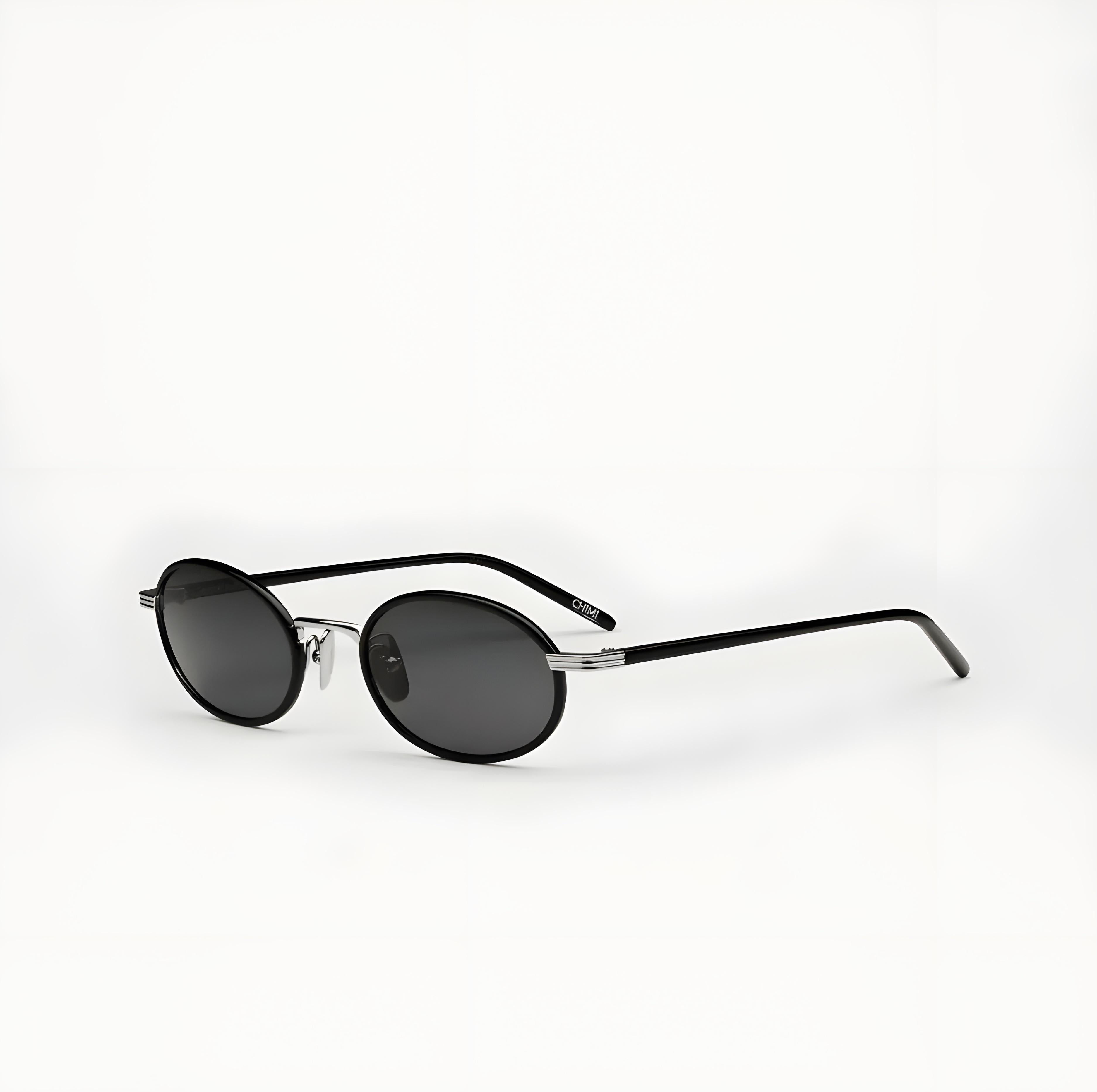 Sunglasses with a black frame and dark lenses on a white background
