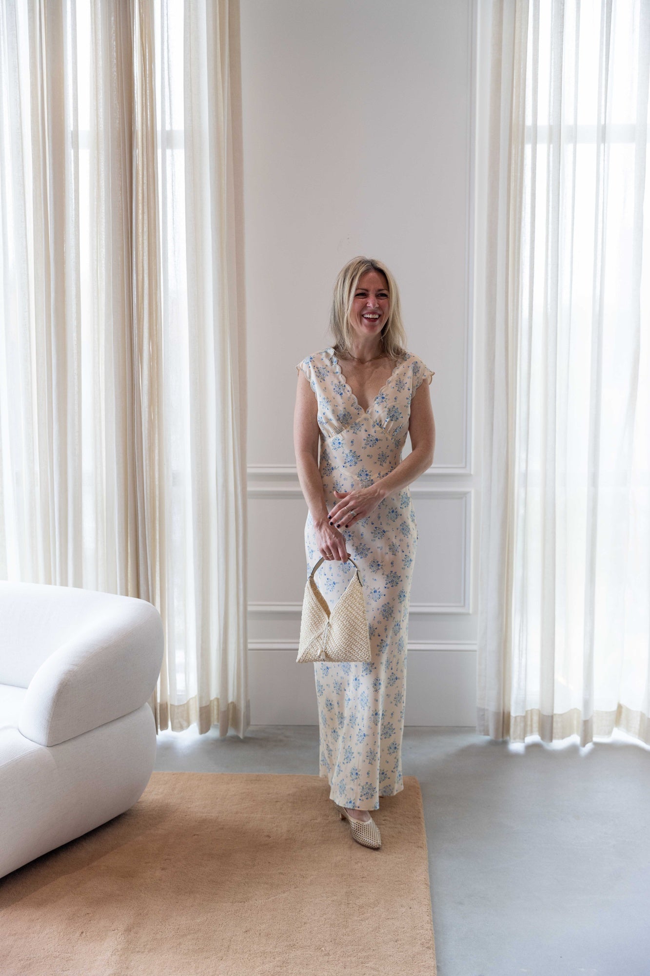 Woman wearing the ciao lucia marja dress and the rachel comey clemmie heel holding the hunting season small origami handbag.