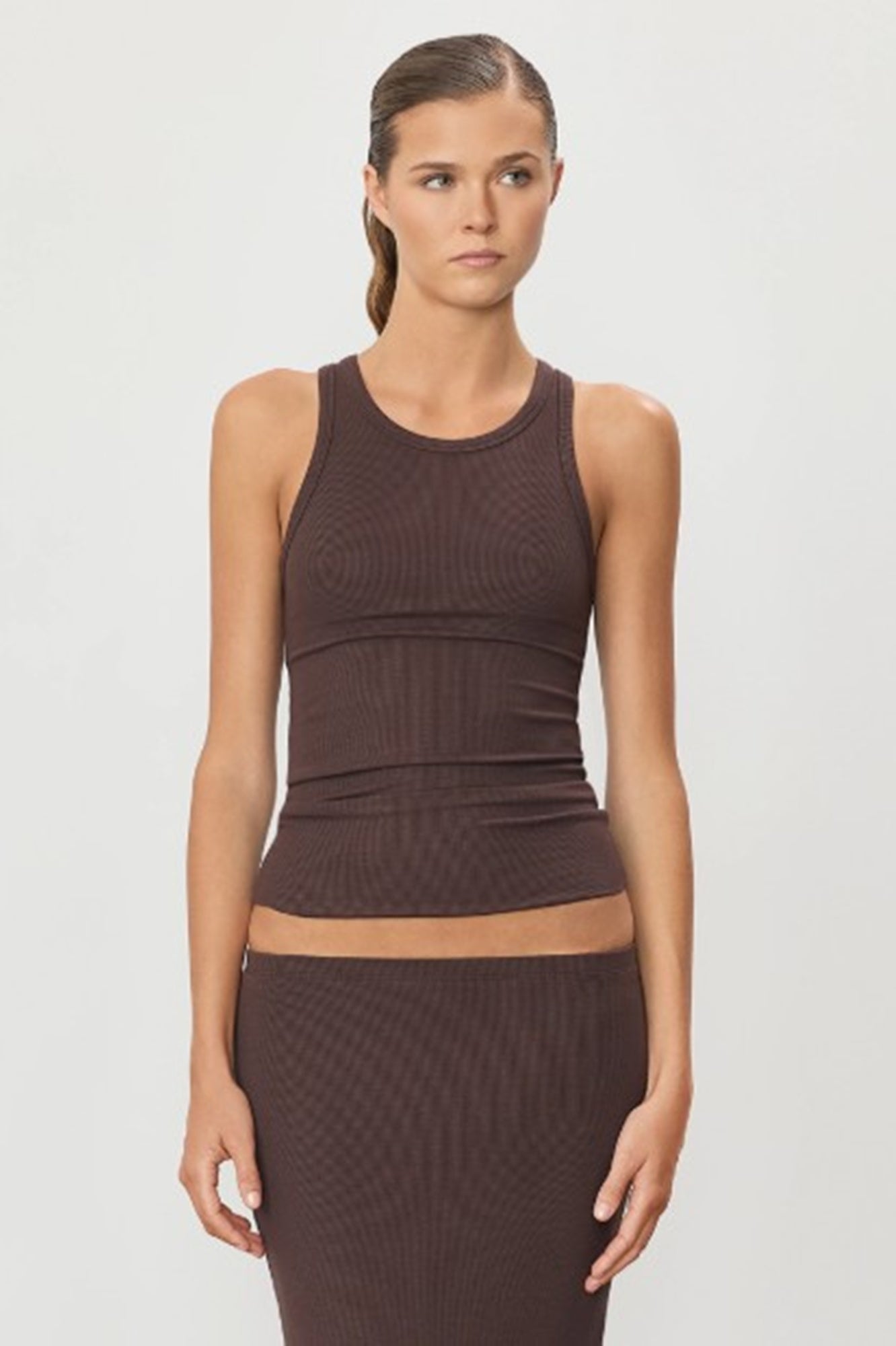 image of a model wearing the Eterne high neck tank in espresso