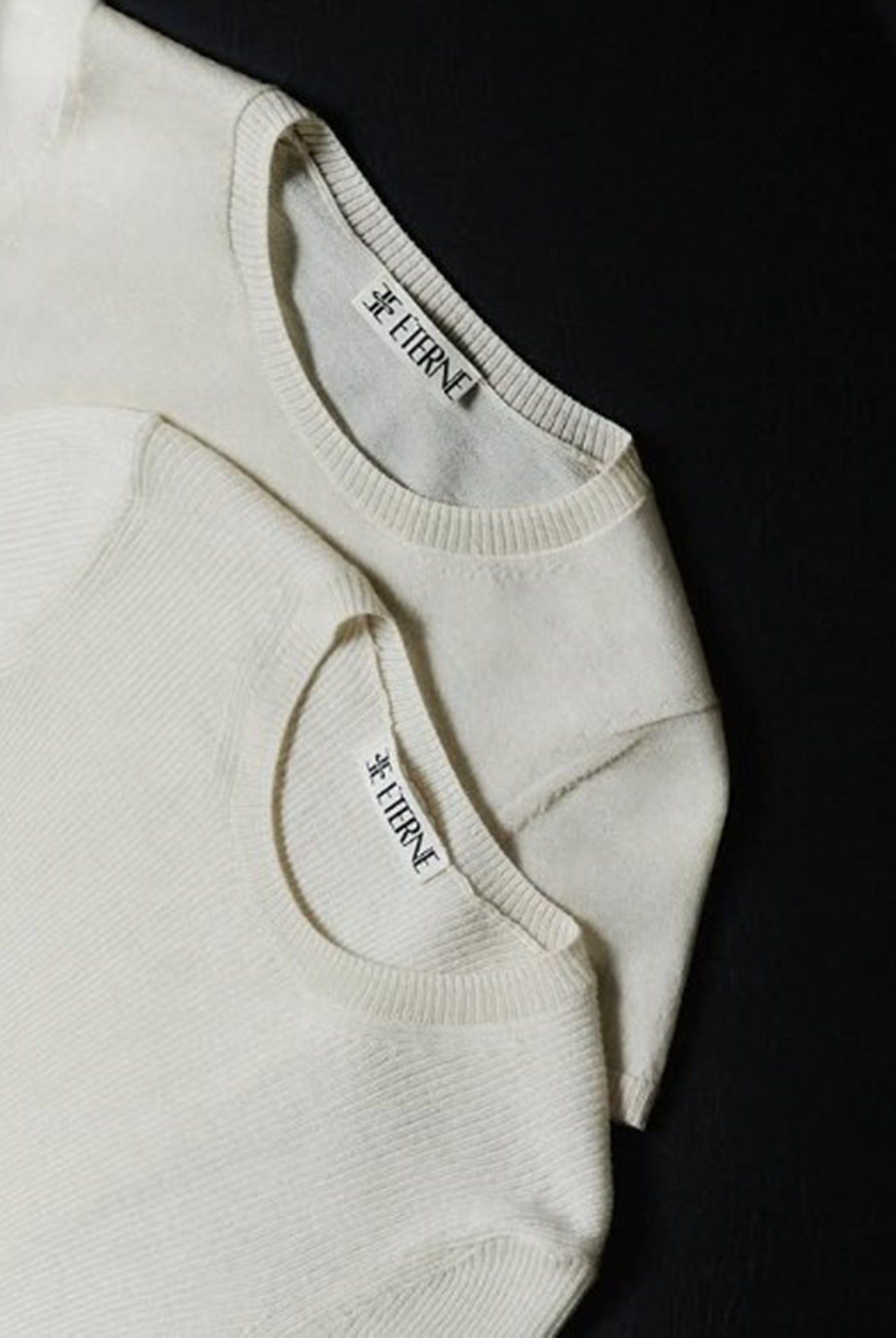 Close-up of a beige sock with a brand label on a black background