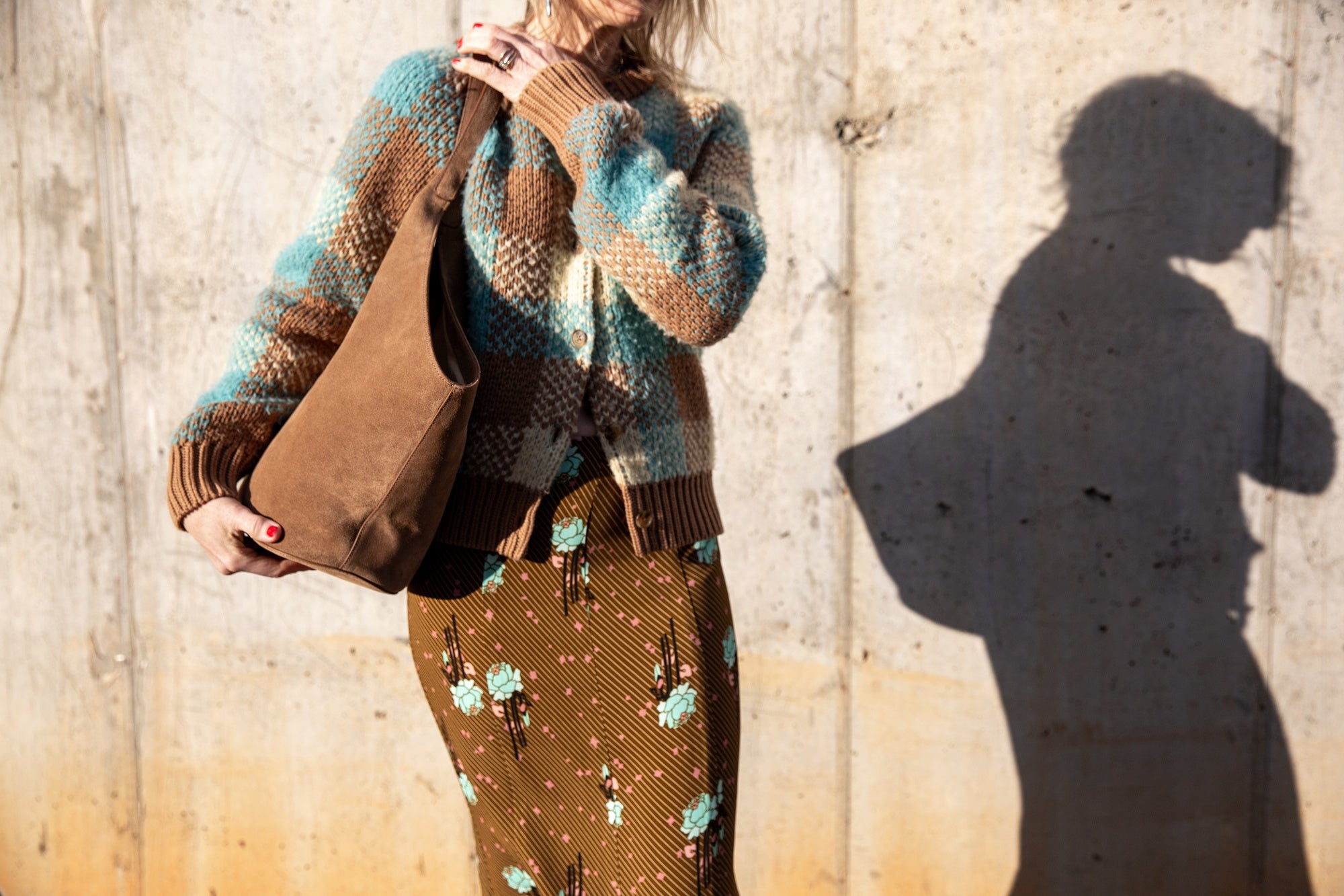 image of a woman wearing the Guest in Residence Buffalo Plaid Cardigan and Rachel Comey Blushing Skirt with an Aesther Ekme Handbag