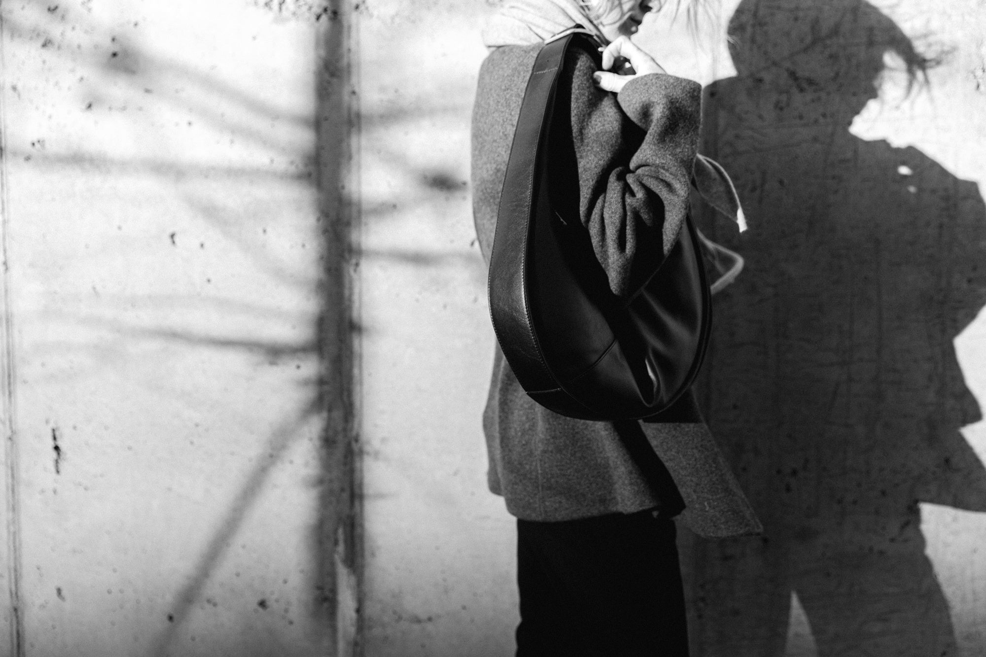 image of a woman wearing the Rachel Comey Nelam Pants and Guest in Residence Tailored Blazer and Vest with the Janessa Leone Handbag