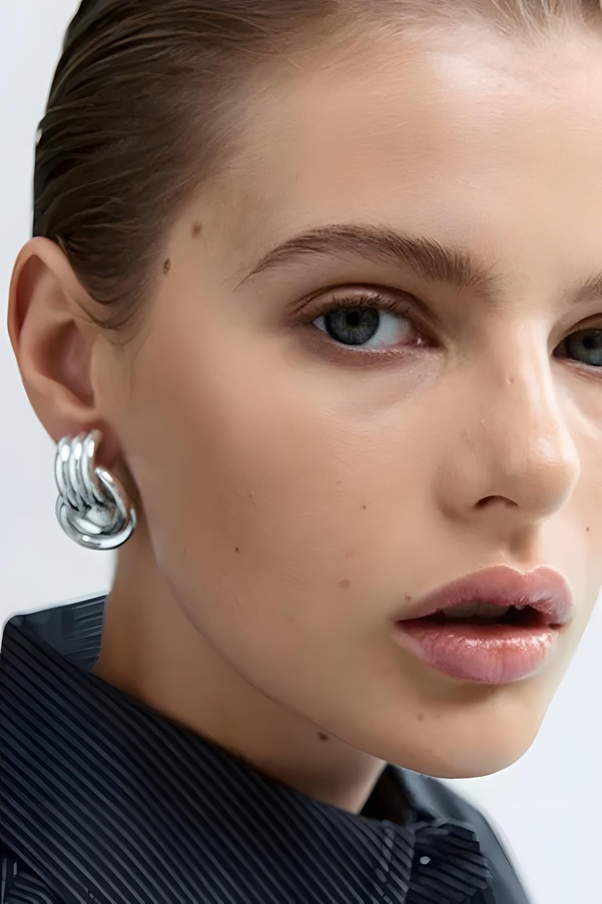 image of a model wearing the Heaven Mayhem Mini Knot Earrings in Silver