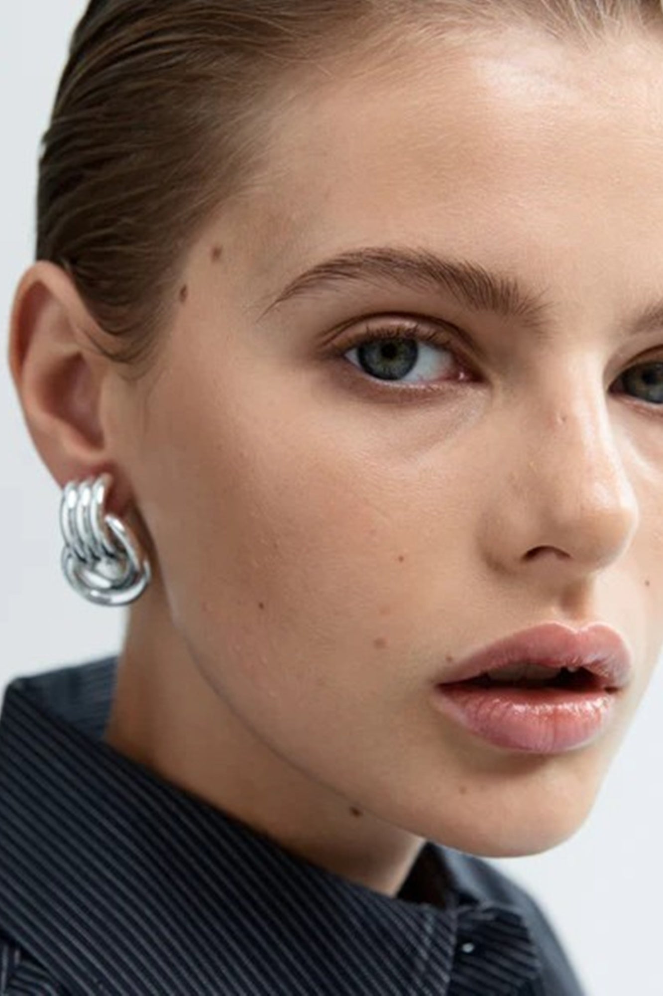 image of a model wearing the Heaven Mayhem Mini Knot Earrings in Silver