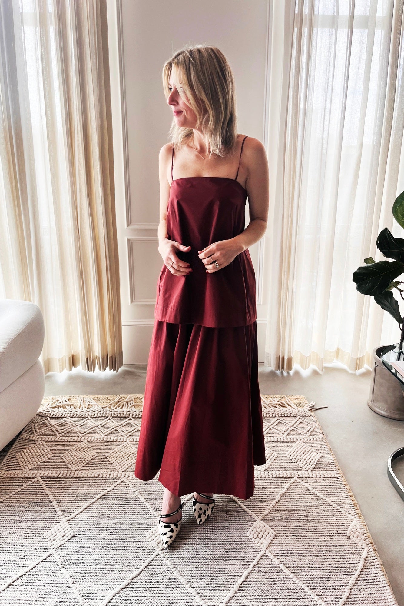 image of a woman wearing the House of Dagmar cotton midi dress in mahogany