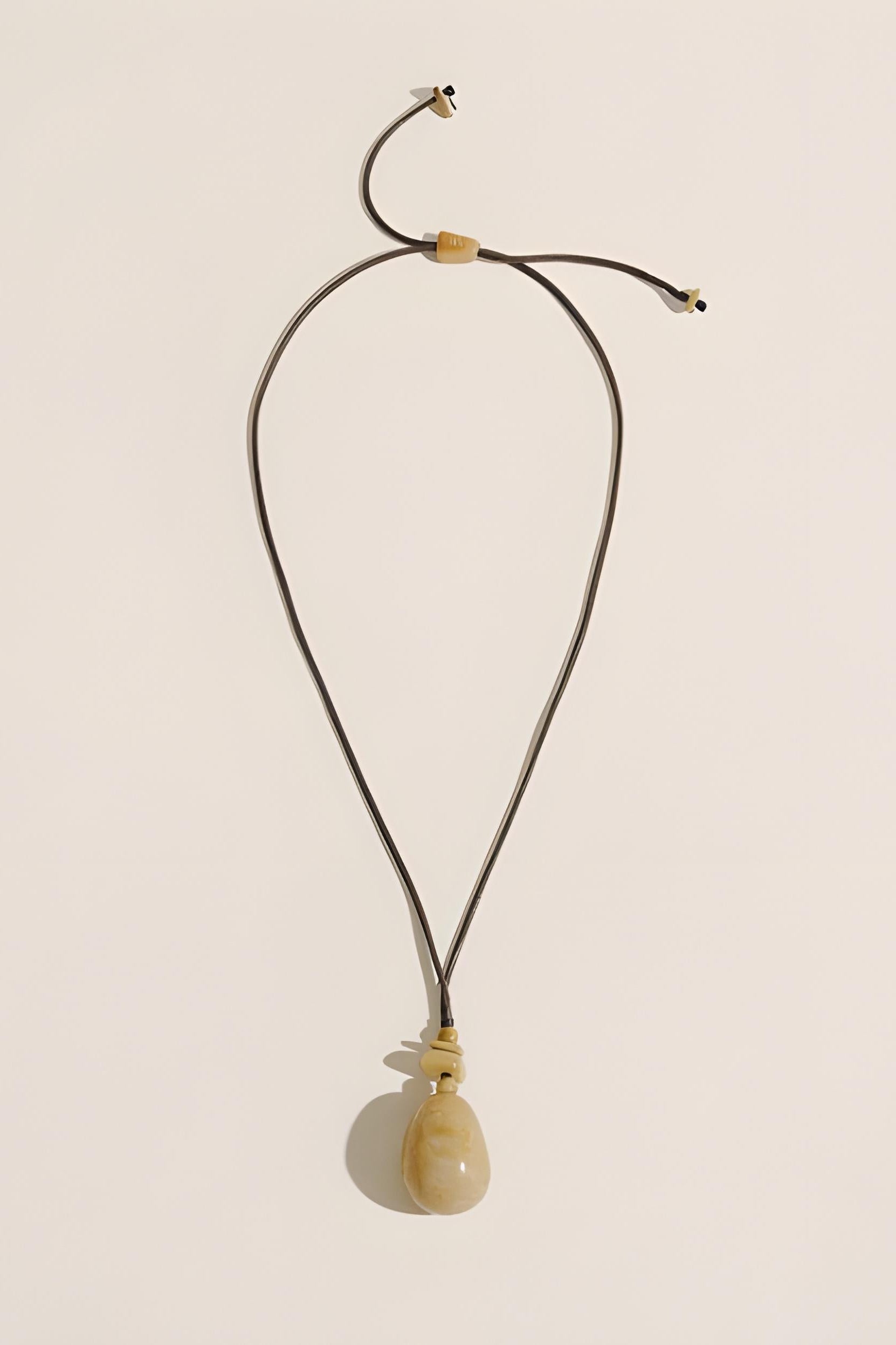 Necklace with a pendant on a beige background
